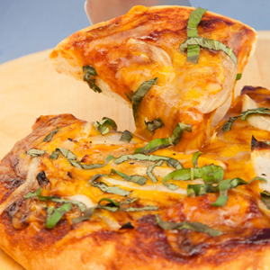 Cheesy BBQ Pizza with Caramelized Onions and Basil